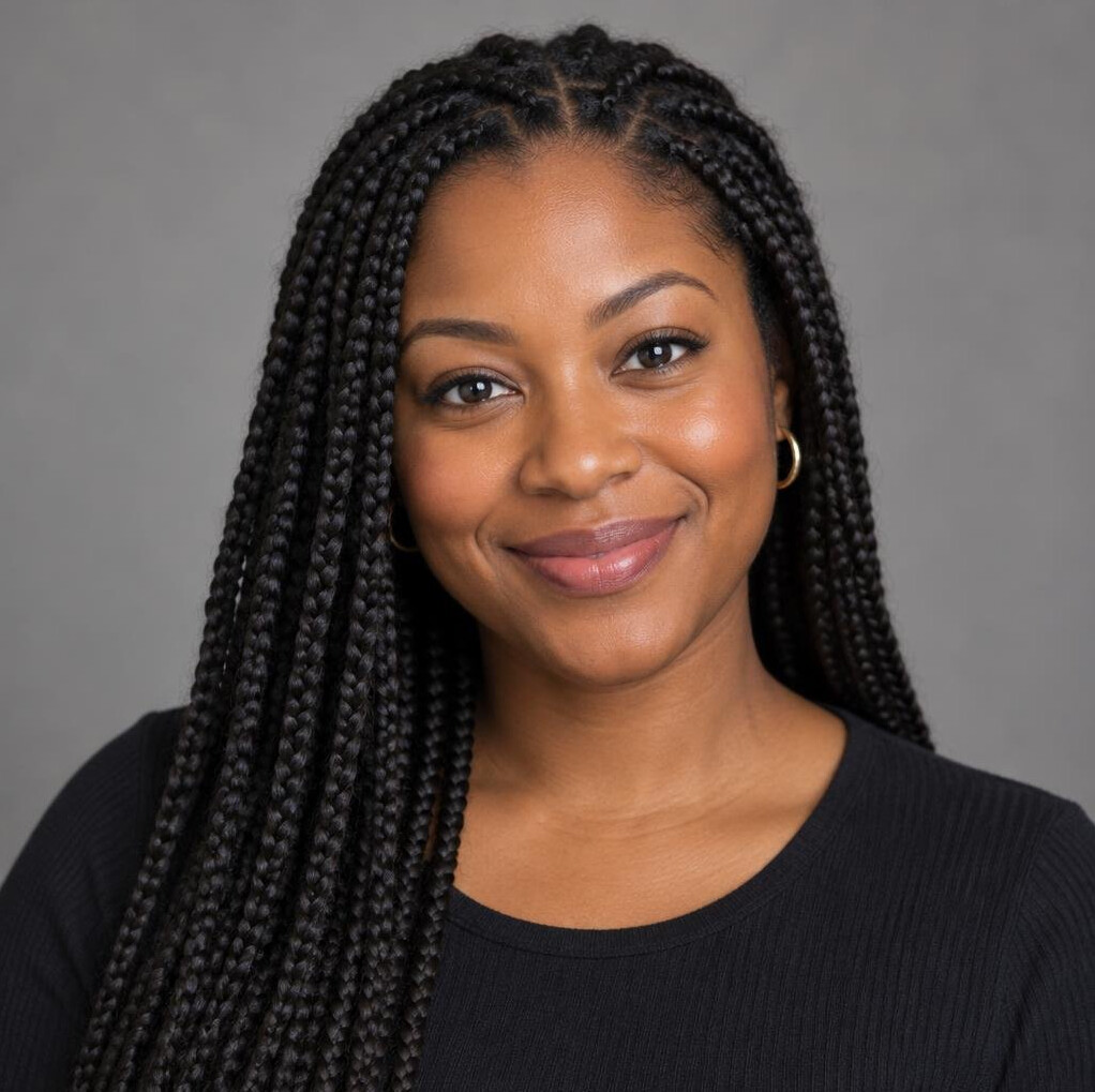 Portrait of a Black woman with braided hair smiling